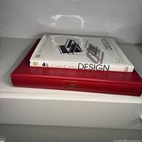 Two books stacked: top Great Design, bottom red Famous Artists School Volume 3