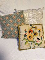 Three cushions grouped on a white surface