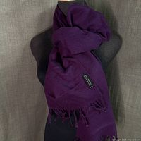 Scarf draped on mannequin showing size and fringe