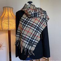 Scarf draped on blazer showing full pattern and label