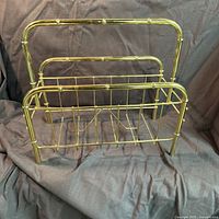 Front view of gold-tone faux bamboo magazine rack showing overall structure