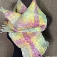 Full view of scarf draped on mannequin showing plaid pattern and texture