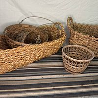 All baskets displayed front view on striped rug