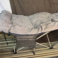 cot with quilted pad and side organizer visible