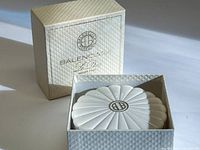Container in box showing scalloped lid and quilted outer box