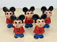 Group of five Mickey Mouse blow-mold figures standing on table
