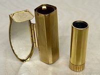 Open lipstick holder showing mirror, inner chamber and refill tube