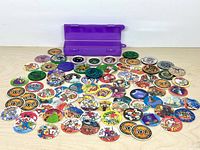 Wide view of entire pog collection, slammer and purple case
