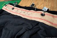 burlap header with handwritten dimensions, grommets and Y hooks visible