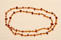 Full length of carnelian bead necklace laid out