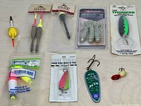 All items in lot laid out for overview showing floats, lures and packaging