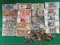 Group shot of all banknotes and coin pile
