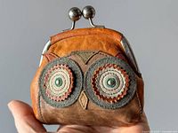 Front view showing owl design and clasp