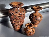 Three Banksia nut vases grouped together