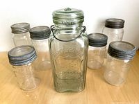 Front view of seven jars highlighting Perfect Seal jar and surrounding Crown/Corona jars