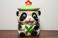 Front view of panda bear cookie jar with lid in place