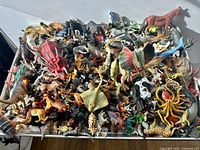 tray filled with mixed plastic animal figurines