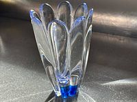 Angled side view showing blue-cored clear crystal vase with petal lobes