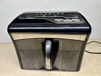 Front view of Staples MailMate shredder with bin installed