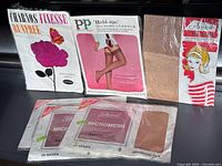 Front view of all five packaged stockings displaying brands and models