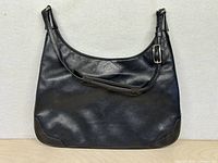 Front view of black leather Coach shoulder bag
