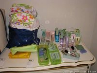 Clinique skincare and makeup products with floral cosmetic bags on a white surface