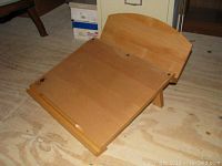 View of Levenger wooden editor's desktop angled upwards with adjustable tacked writing surface and raised back panel