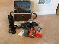 Full view of lot including camera, lenses, flash, accessories, case, and Mico Vue boxes