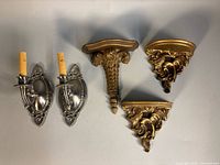 Group shot: pair silver sconces, three gold Syroco wall shelves