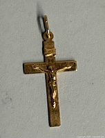 Full view of gold crucifix pendant showing overall design