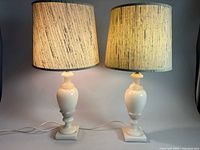 Both alabaster table lamps lit