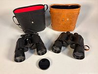 Two binoculars, two cases, single lens cap