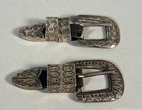 Both sterling silver Navajo belt buckle sets front view