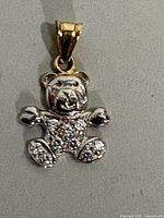Front view of teddy bear pendant showing cubic zirconias and gold bail