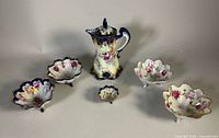 Full lot showing chocolate pot, four footed bowls and small dish