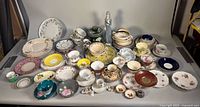 Overview of assorted plates, teacups, saucers and figurine