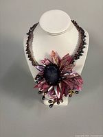 Full view of floral choker on display bust
