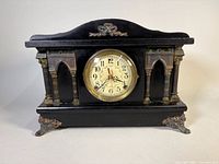 Front view of black Sessions mantel clock