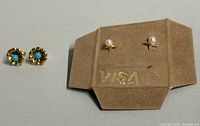 Both pairs of earrings on card showing design and size