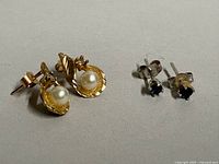 Two pairs of earrings side by side showing overall design and size comparison