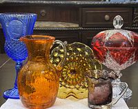 Group shot of all five glass pieces showing colors and forms