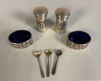 Full set: two shakers, two cellars with liners, three spoons