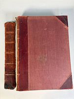 Closed volume with detached spine piece alongside