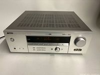 Front angled view of Yamaha HTR-5750 receiver showing top vents and front controls