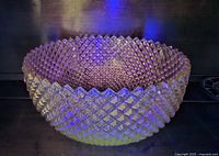 Bowl glowing under UV light showing uranium content