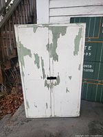 Front view of closed cabinet showing distressed paint