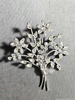 Front view of Carl-Art sterling silver floral crystal brooch