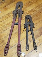 Full view of both bolt cutters side by side showing relative sizes and finishes