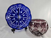 Blue cut to clear platter on stand beside amethyst bowl