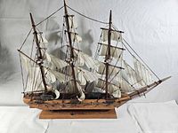 Port side view showing full sails, masts, rigging and hull details